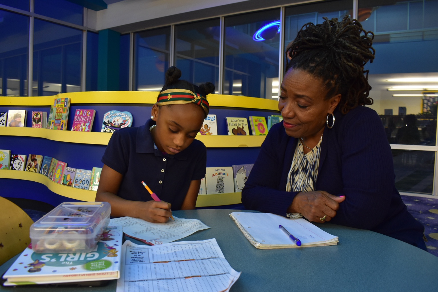 Donna Jones supporting a student during a learning activity